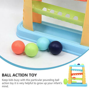 Pounding balls (orange, green, light blue, dark blue) beside a blue ball tray.