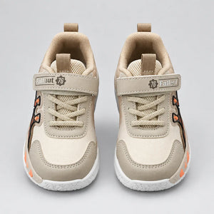 Beige No.1 chunky kids sneaker with strap and white sole, side view