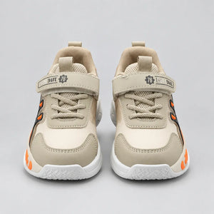 Beige No.1 light-up kids sneaker with orange sole detail, three-quarter view