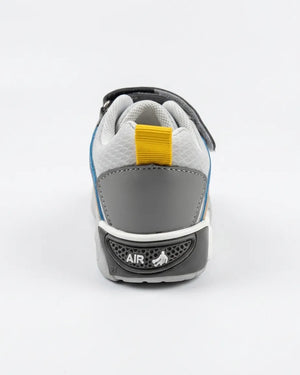 Child wearing grey and blue Velcro sport sneakers