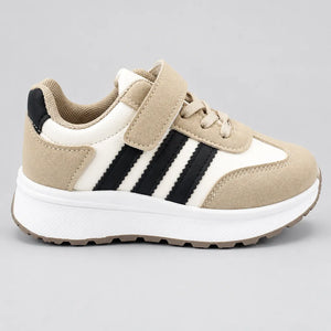 Side view of PrimeBee kids sneaker showing beige, white and black panels and chunky sole