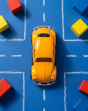 Volkswagen Beetle diecast model car toy, yellow-orange, top view
