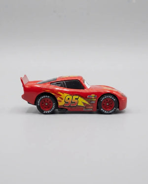 Red diecast pull-back car, side view, #95 lightning graphic