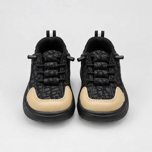 Black Trail kids sneaker with tan toe and heel panels, inner side view