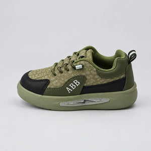 Green Trail kids sneaker showing dark toe panel and heel pull tab, inner side view