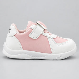 Alternate side view of a pink and white kids’ sneaker with a white sole.