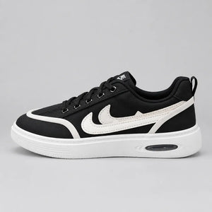 Front view of Black DuoTrim kids sneakers showing black laces and white toe trim