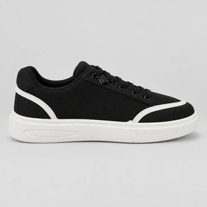 Inner side of Black DuoTrim kids sneaker showing white trim and low-top profile