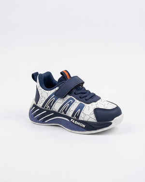 Three-quarter view of navy and white kids strap sneaker showing navy laces, patterned upper and toe cap