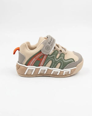 Side view of child wearing beige and olive kids sneakers