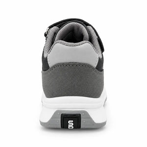 Side view of grey and black kids’ sneaker with three light stripes and a white sole