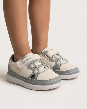 Side view of pink and cream cartoon sneakers for kids with strap fastening