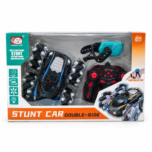 Boxed double-sided stunt car with handheld remote and turquoise gesture-control watch, marked ages 6+