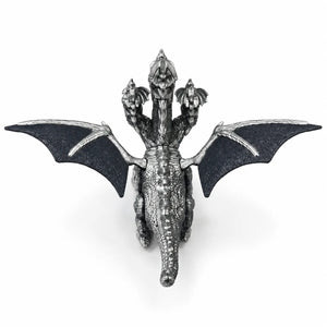Rear view of the three-headed dragon toy showing wide wings, textured scales and long tail