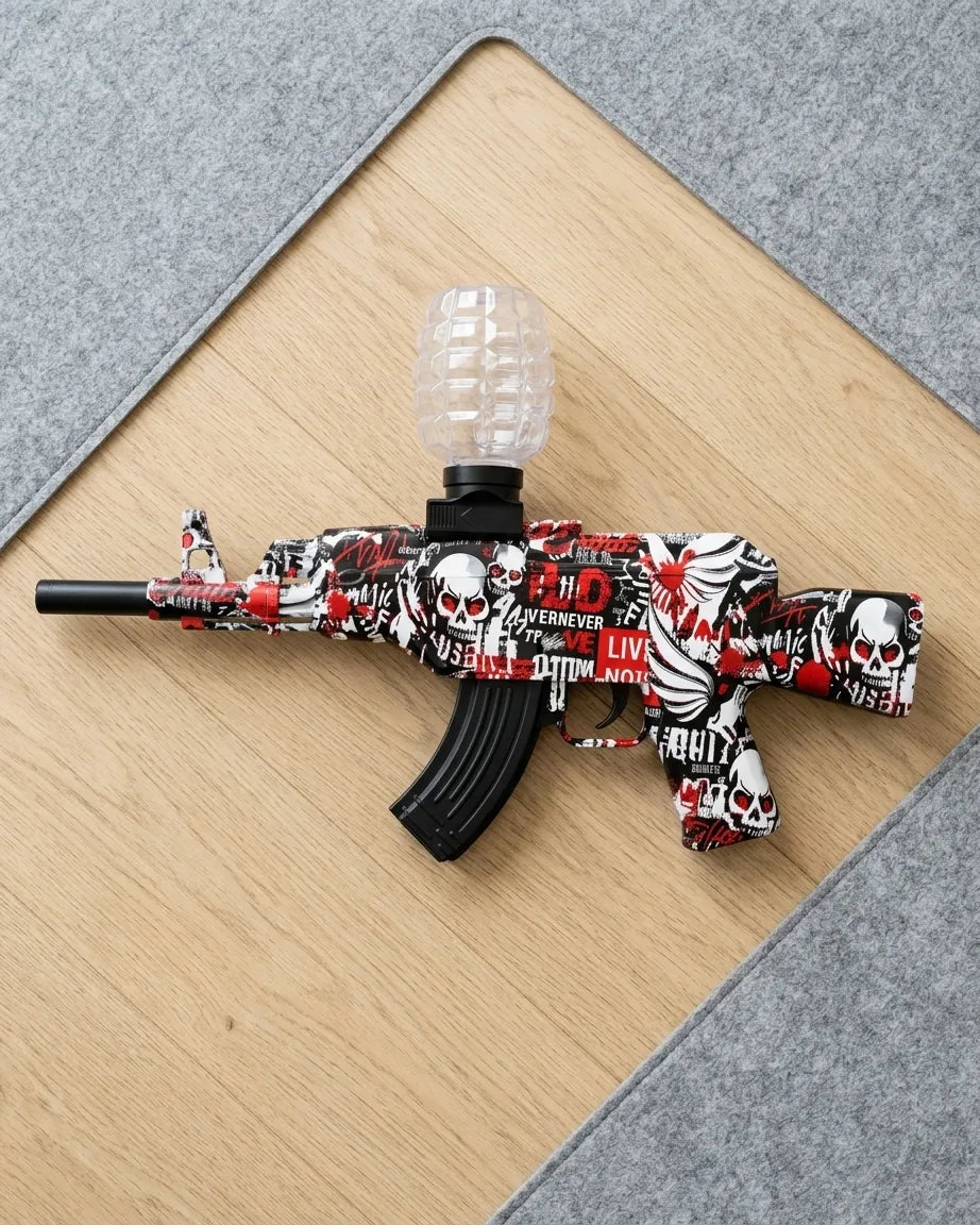 Gel blaster toy gun with skull graffiti, curved black magazine, and clear hopper