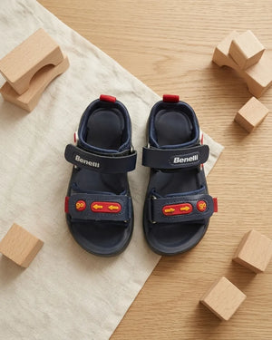 Side view of navy kids sandal with red starfish decoration and back strap