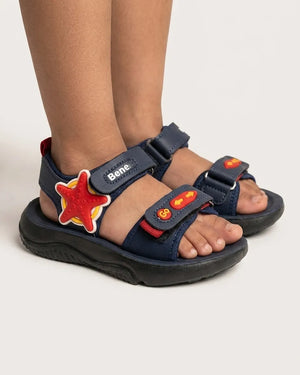 Navy starfish kids sandals arranged beside wooden blocks