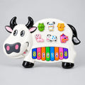 White cow-shaped piano toy with eight colourful numbered keys and raised character buttons