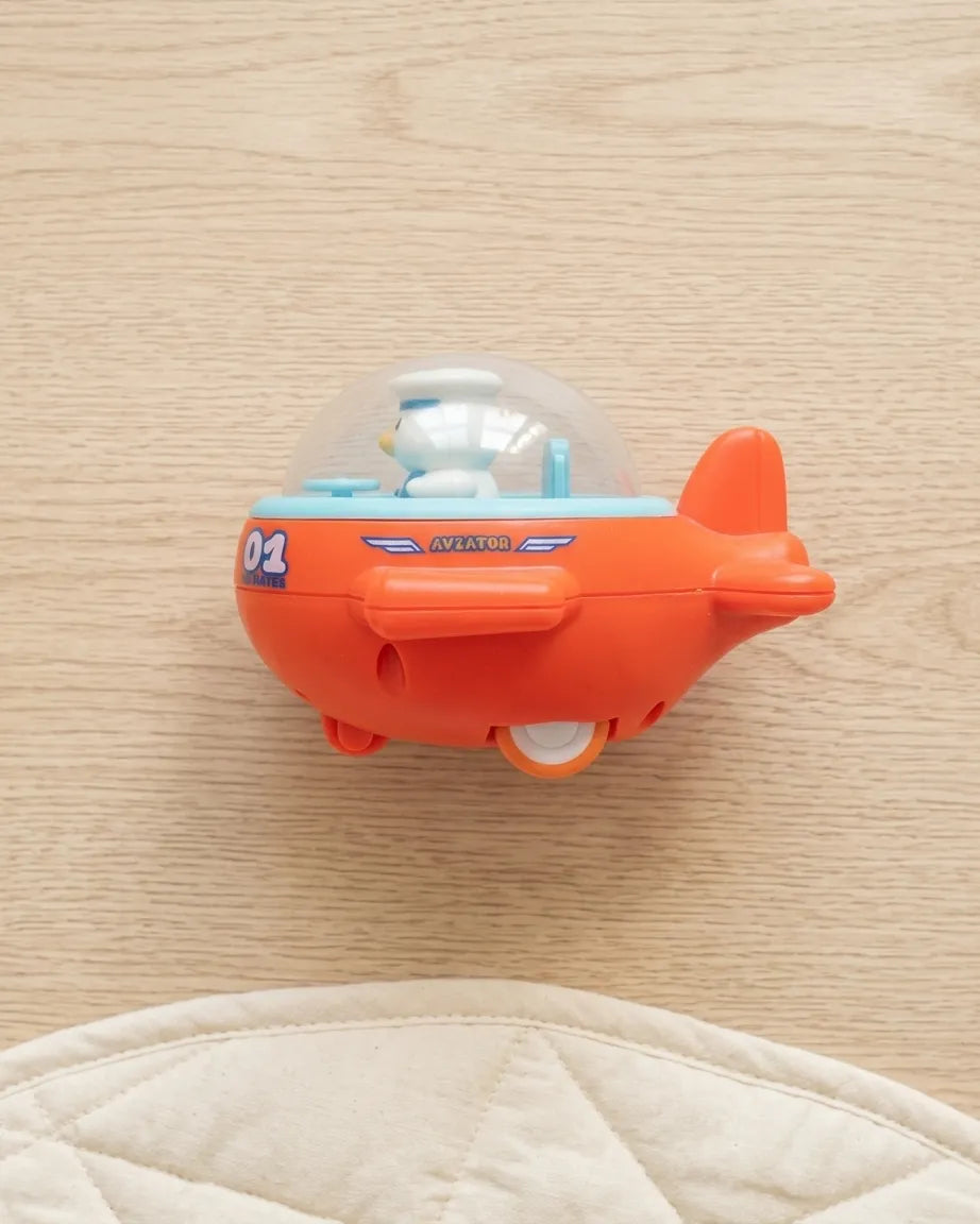 Orange mini airplane toy with clear dome cockpit and snowman pilot figure, side view.