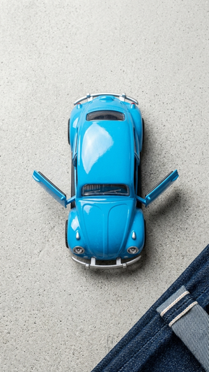 Blue diecast Beetle model car toy, top view with open doors