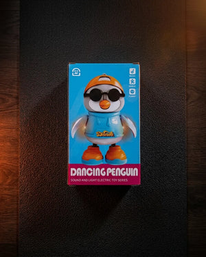 Dancing penguin toy retail box showing blue penguin figure with orange boots and goggles