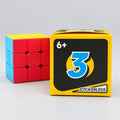 Stickerless 3x3 cube beside yellow packaging marked ages 6+ and stickerless