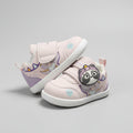 A pair of toddler's light pink and white velcro shoes with a cute cartoon character on the side, displayed on a white table in a store.