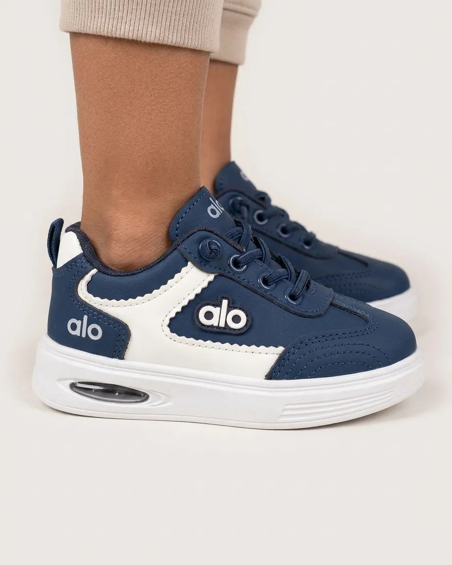 Grey Alo kids sneaker side profile with black contrast panel and white chunky sole