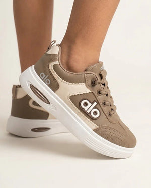 Beige Alo kids sneaker side profile with cream contrast panel, raised lettering and white sole