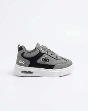 Pair of blue Alo kids sneakers from the front with navy laces and white soles