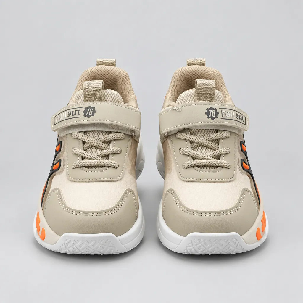 Beige No.1 light-up kids sneaker with orange sole detail, three-quarter view