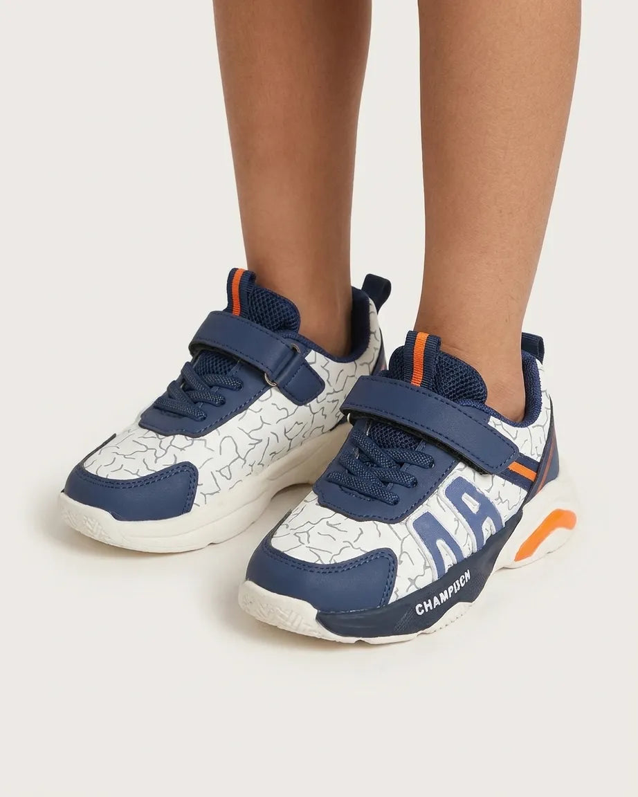 Top view of navy and white kids sneakers with straps and navy laces
