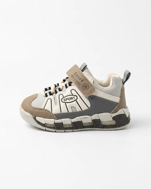 Side view of beige, grey and white kids sport sneaker with strap and chunky segmented sole