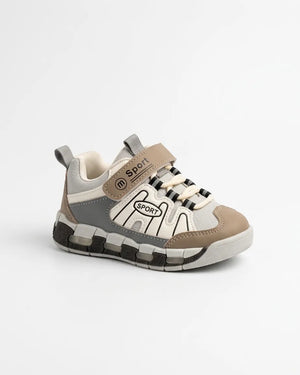 Pair of beige, grey and white kids sport sneakers with straps worn with socks