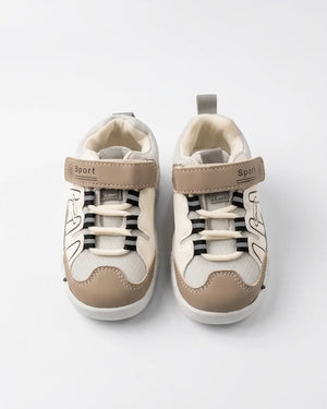 Top view of beige, grey and white kids sport sneakers showing straps and elastic-style laces