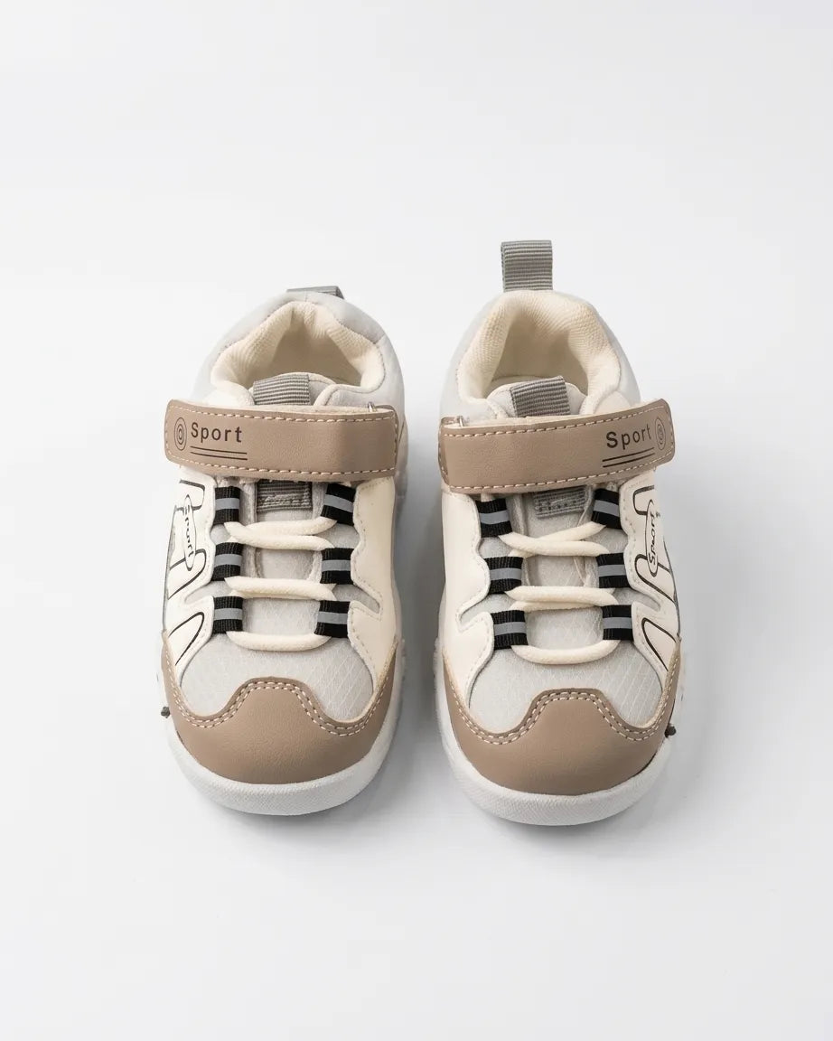 Top view of beige, grey and white kids sport sneakers showing straps and elastic-style laces