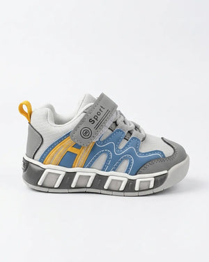 Back view of grey kids sneaker with yellow heel pull tab