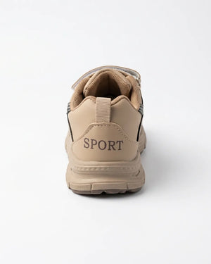 Side profile of beige kids chunky sneaker showing strap and patterned sole