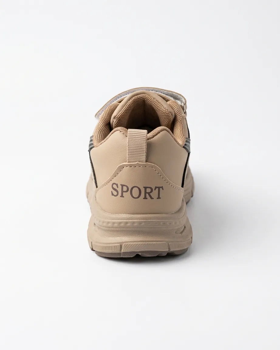 Side profile of beige kids chunky sneaker showing strap and patterned sole