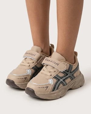 Back view of beige kids sneaker with heel pull tab and chunky sole