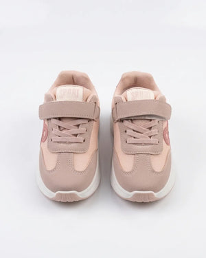 Side view of pink girls' sneaker with tonal side detail and white sole