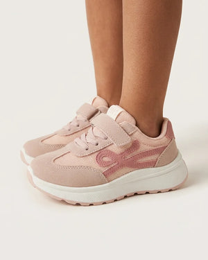 Pink girls' sneakers with straps and chunky white soles styled on foot