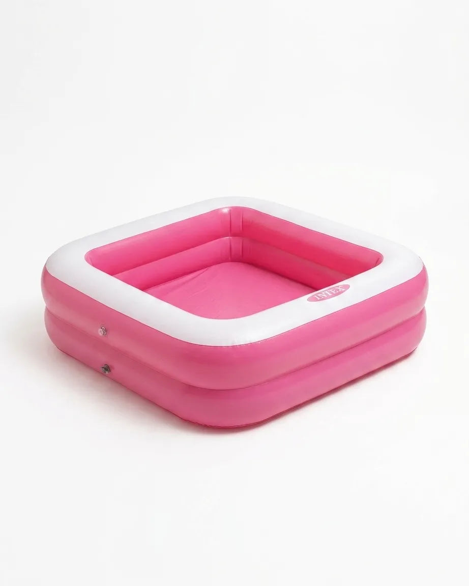 Pink inflatable kids play pool with white rim and shallow water basin