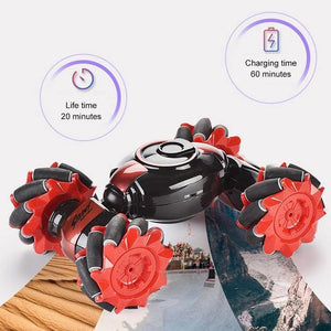 Red and black stunt RC car with four treaded wheels and glossy shell