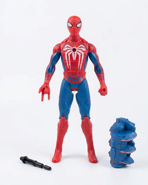 Spider-Man action figure in red and blue with a large white spider emblem on the chest, standing on a white background with a small black accessory and a blue component beside it.