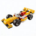 Yellow and red brick race car model with white accents, chunky tires
