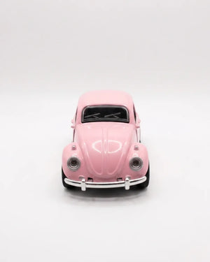 Volkswagen Beetle diecast model car toy, light pink front view with grille and headlights