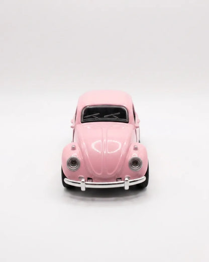 Volkswagen Beetle diecast model car toy, light pink front view with grille and headlights