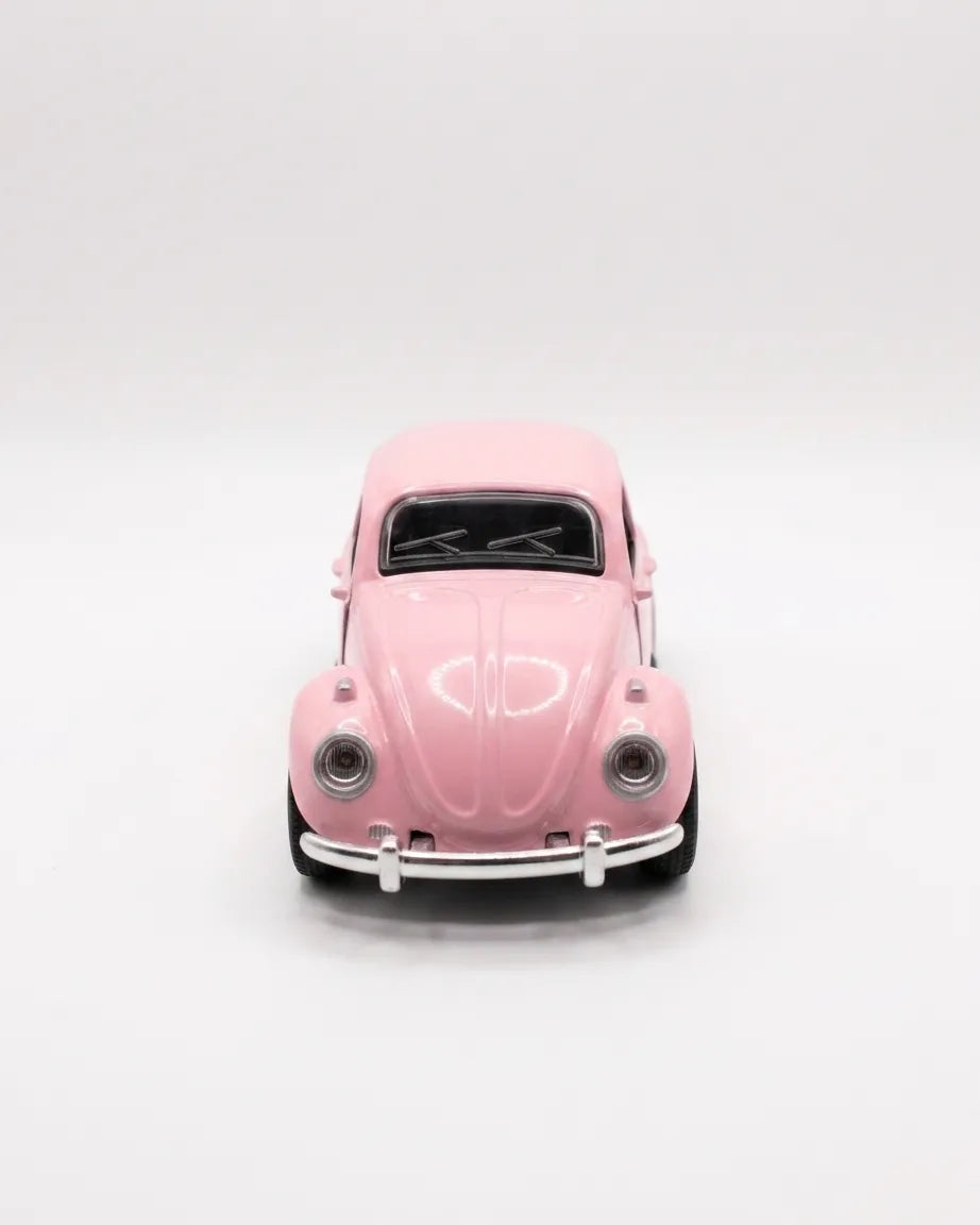 Volkswagen Beetle diecast model car toy, light pink front view with grille and headlights