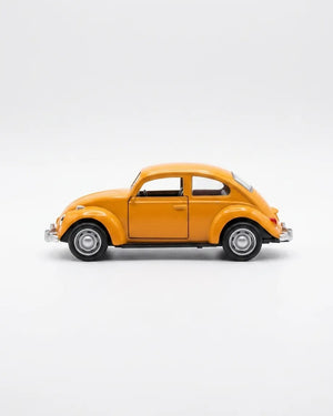 Volkswagen Beetle diecast model car toy, yellow-orange, side profile with chrome details